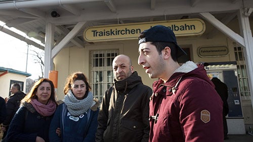 Mohammed Abu Saleh, right, and his father fled Syria, leaving behind his sister and mother. The family was reunited in Austria. (Photo by Courtney Pedroza/Cronkite Borderlands Project)