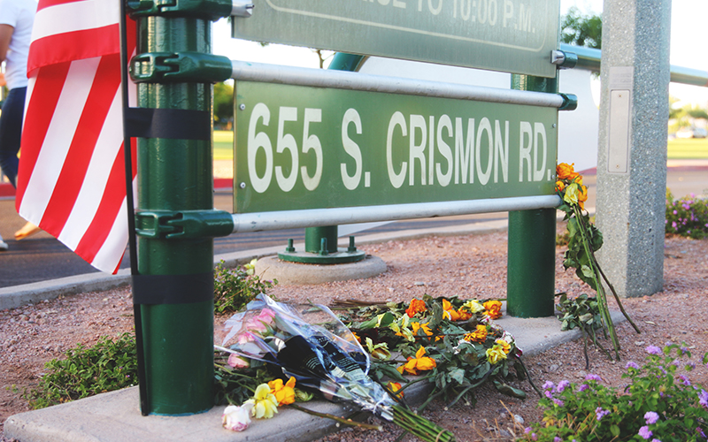 Flowers and an American flag were placed at the entrance of Skyline Park, in remembrance of Orlando victim Jason Josaphat. (Photo by Christopher West/Cronkite News)
