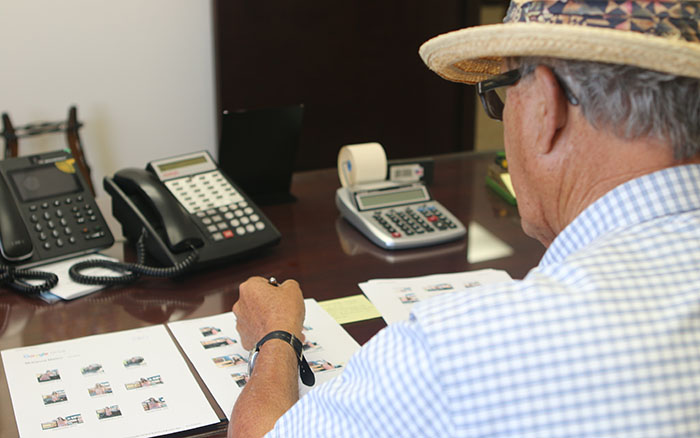 Farmer Doug Mellon, seen sitting at his desk, has witnessed the evolution in migrant labor policy throughout several decades in the agricultural industry. (Photo by Socorro Carillo/Cronkite News)
