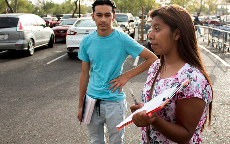 Yenni Sanchez, 18, has registered people to vote for three years. She said that she registers as many people as she can because she isn't eligible to vote. Daniel Flores, 16, is also a volunteer. (Courtney Columbus/News21)