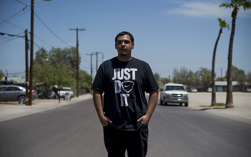 David Castorena, 24, of Chandler, Arizona, stands in the street of a small, largely-Latino community where he attends church. Castorena said he does not plan to vote in the upcoming November Election because he thinks that Donald Trump will win either way. (Photo by Roman Knertser/News21)