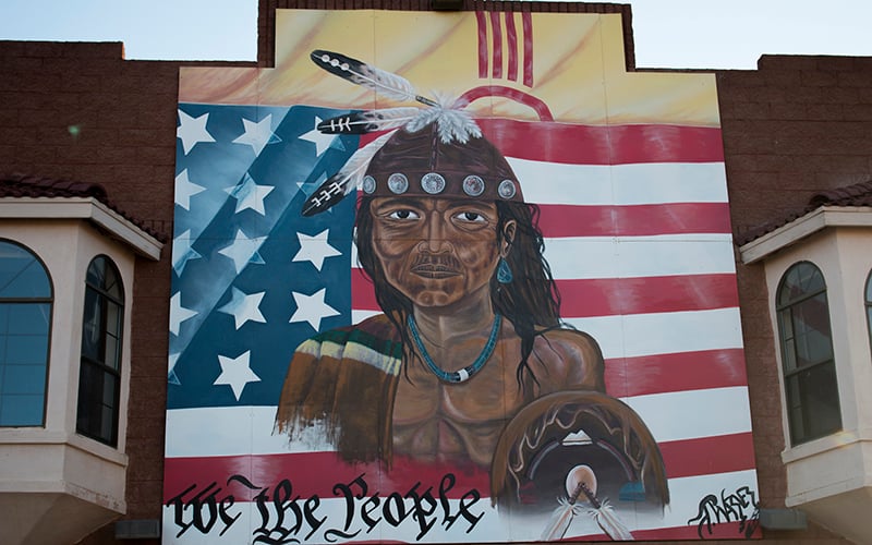 Mural of a Native American on the side of a trading post that sold goods from tribes on the Navajo Nation near Gallup, New Mexico. (Photo by Mike Lakusiak/News21)