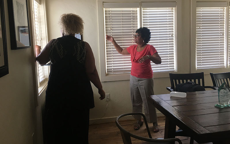 Ladina Willis (left) and Angela Booker of the Mesa MLK Committee joke around in the house of Mesa's first practicing African-American doctor, which they currently lease from the city and hope to turn into a museum. (Photo by Elizabeth S. Hansen/Cronkite News)