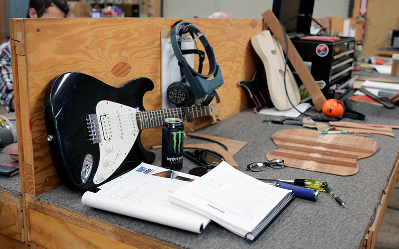 Students build guitars at work stations. The school teaches a craft that fashions guitars from a block of wood to instruments for stage, school auditoriums or homes. (Photo by Joshua Bowling/Cronkite News)