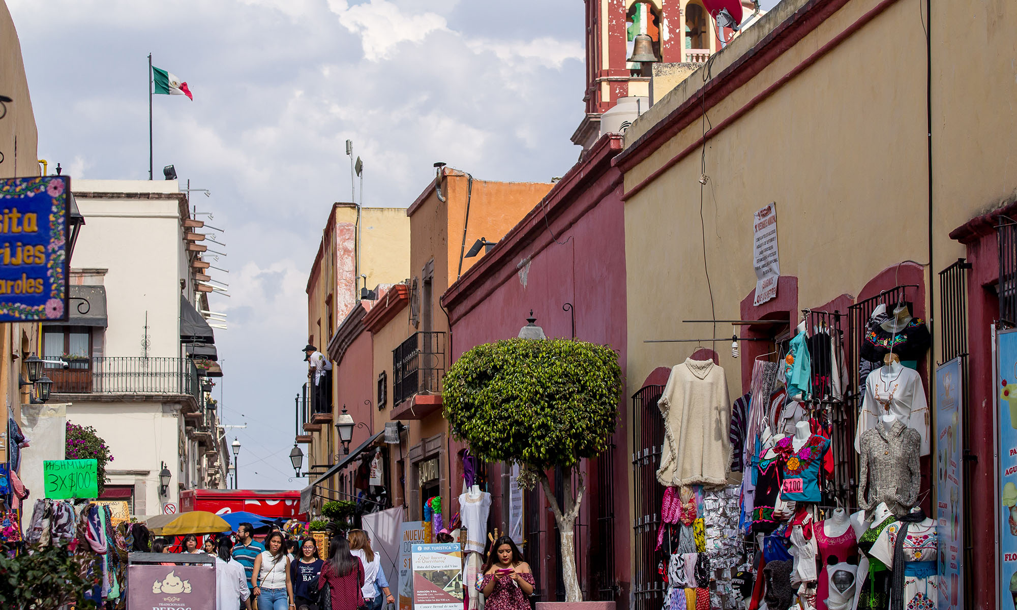 Tourists and locals visit shops and restaurants nestled in old Spanish-style buildings, which are one of the unique characteristics of downtown Santiago de Querétaro in Mexico.
