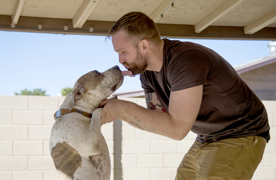 John Koch plays with his dog, Conrad, outside his Mesa home. In January 2016, he testified before the Arizona Senate to advocate for more access to the lifesaving drug, Narcan. (Photo by Ben Moffat/Cronkite News)
