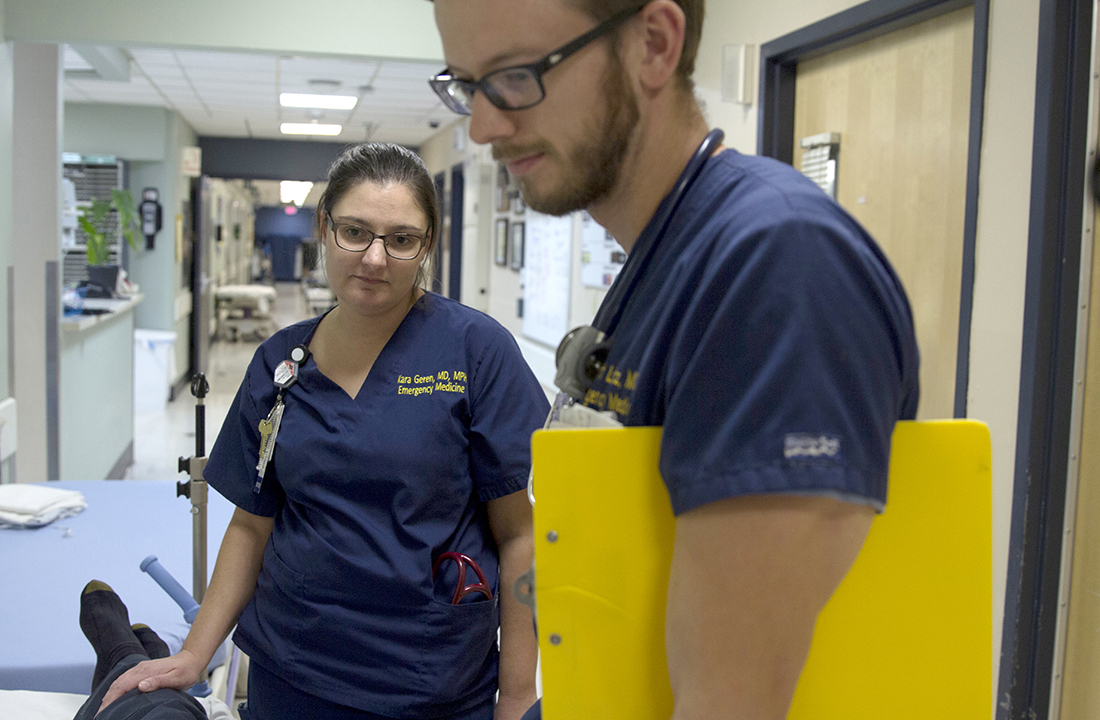 Dr. Kara Geren and Scott Lotz, a second-year resident at Maricopa Integrated Health System, discuss patient treatment. (Photo by Ally Carr/Cronkite News)