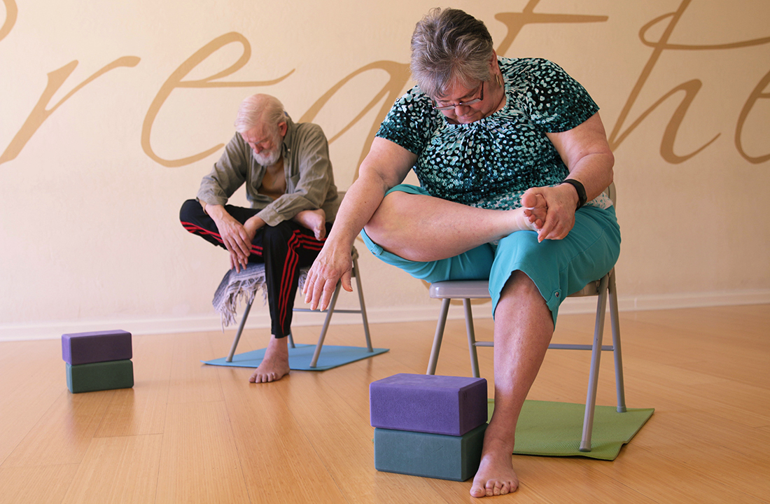 RJ Davis (right) and Geoffrey Davis take a chair yoga class at Inner Vision Yoga Studio in Chandler. (Photo by Ao Gao/Cronkite News) 