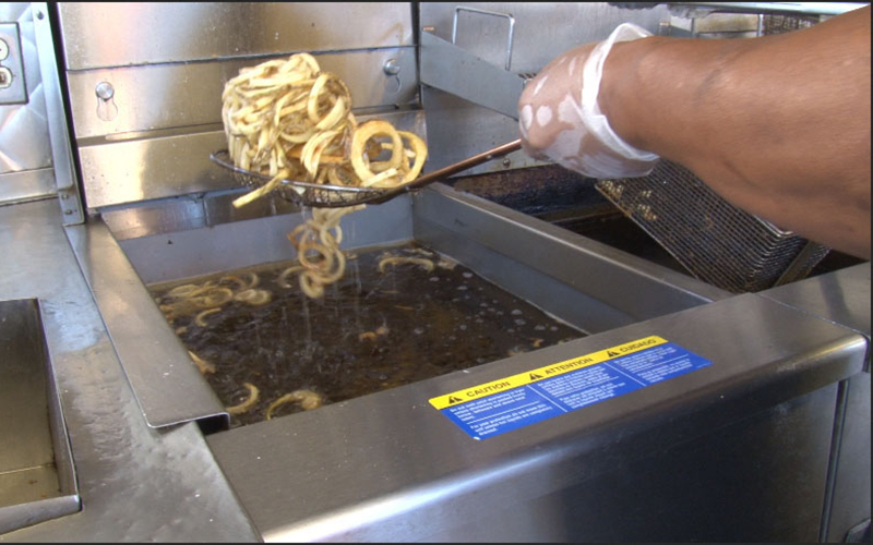 After a couple days of being used to make Piggly Fries, the vendor takes the oil from the deep fryer to be recycled into fuel. (Photo by Natalie Tarangioli/Cronkite News)