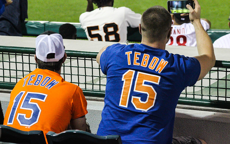 Dave Hansen and his brother James watch Tim Tebow bat during the 8th inning of the Scottsdale Scorpions game against the Surprise Saguaros, Wednesday, Oct. 19 in Scottsdale. (Photo by Nicole Vasquez/Cronkite News)