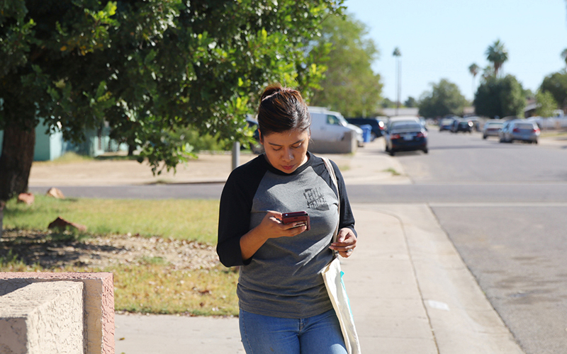 Viri Hernandez revisits heavily Latino neighborhoods in western Maricopa County on Oct. 29, 2016 to ensure voters have mailed in their ballots. (Photo by Andres Guerra Luz/Cronkite News)