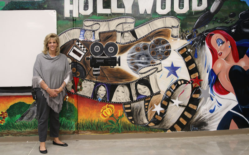 Sawyer, the unit manager who kickstarted the move for the mural, is among the counselors portrayed on the wall. (Photo by Kristiana Faddoul/Cronkite News)