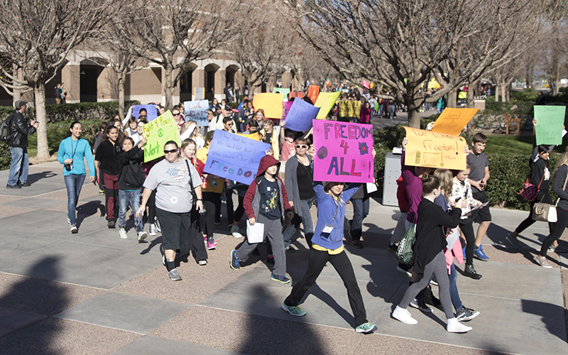 Students and volunteers march during the MLK March on West on the Arizona State West Campus in Glendale on Wednesday, Jan. 18, 2017. (Photo by Josh Orcutt/Cronkite News)
