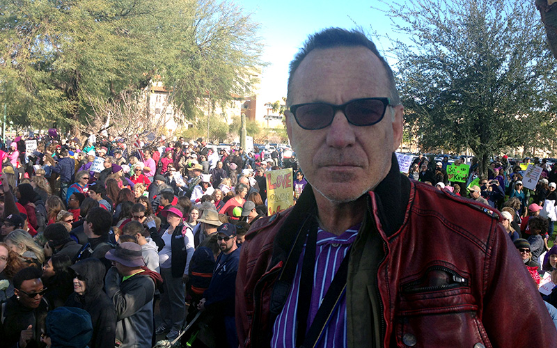 World traveler and photographer Brent Bishop, 60, walked in the Phoenix march to support his daughter, who walked in the Washington, D.C. march. (Photo by Saundra Wilson/Cronkite News)