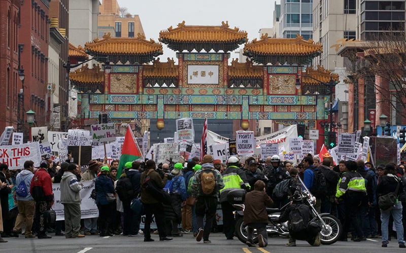 Protesters resting in Chinatown before they continue their march to the White House. (Photo by Dustin Quiroz/Cronkite News)