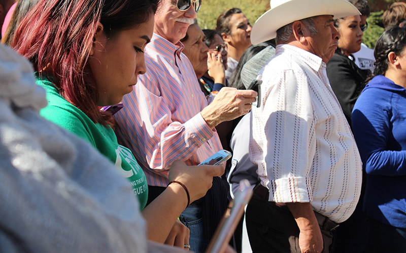 Protestors use their cell phones to call Sen. John McCain and ICE Director Carter asking for Guadalupe Garcia De Rayos' release. (Photo by Charlene Santiago/Cronkite News)