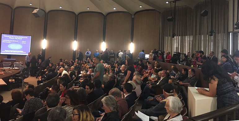 Supporters and opponents of Phoenix becoming a sanctuary city wait in a packed city council chamber for the meeting to begin.   (Photo taken by Sarah Jarvis/Cronkite News)
