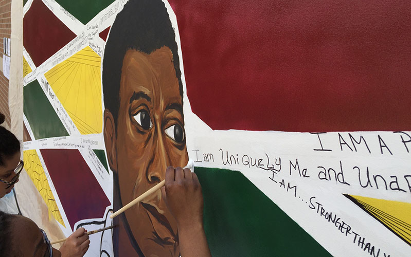The portrait of James Baldwin is surrounded by volunteers' statements of empowerment. (Photo by Jared McDonald/Cronkite News)