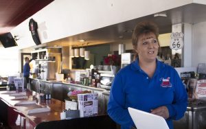 Tammy Rutherford stands in the diner she owns on Route 66 in Kingman, Arizona. A Trump voter, she said he is 