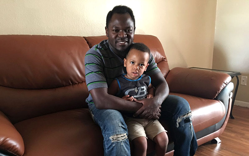 Timothy Zambakari, one of East Africa's most famous musicians, fled war-torn Sudan and settled in Phoenix, where he is raising his two sons, Romeo (2, seen here) and Aaron (1). (Photo by Mindy Riesenberg/Cronkite News)