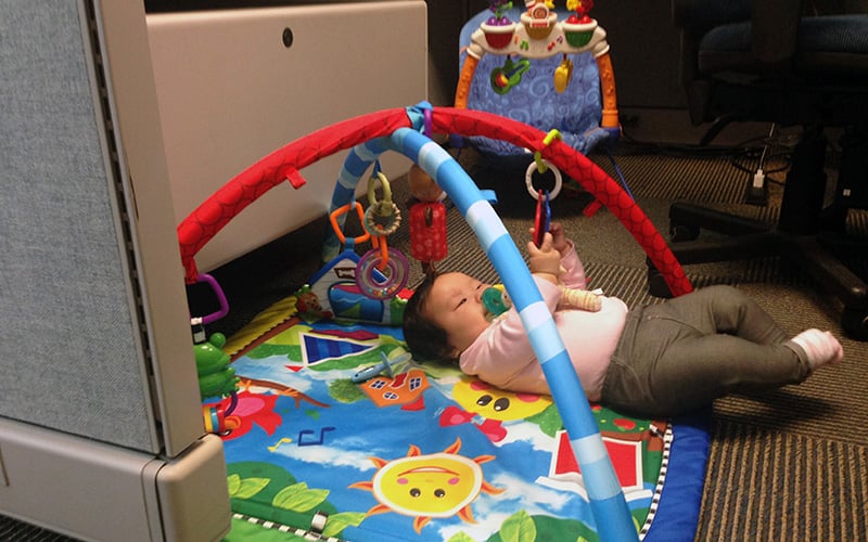 Kevin Watanabe said he will miss playing with his daughter Katelyn at lunchtime after she ages out of the infants-at- work program at six months old. (Photo by Saundra Wilson/Cronkite News)