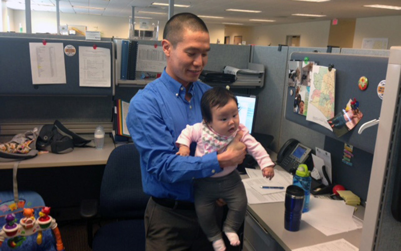 State employee Kevin Watanabe has a stroller, car seat and playmat for his daughter Katelyn in his cubicle. (Photo by Saundra Wilson/Cronkite News)