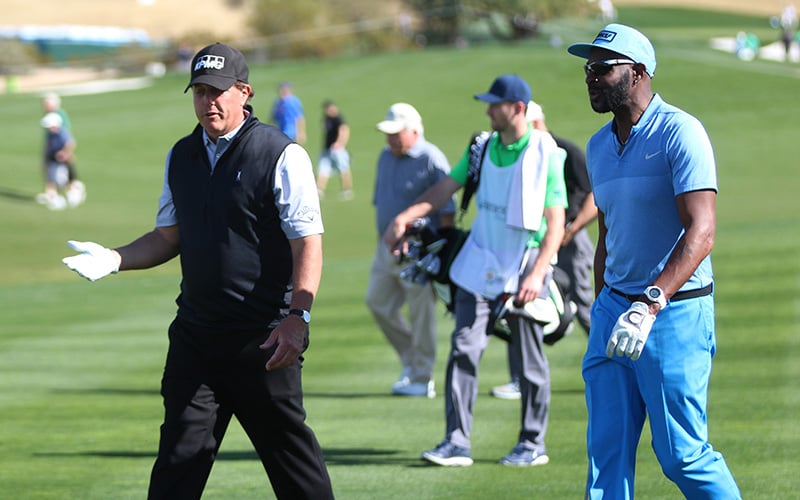 Phil Mickelson and Jerry Rice talk down the fairway during the celebrity pro-am at the Waste Management Phoenix Open. (Photo by Tyler Drake/ Cronkite News)
