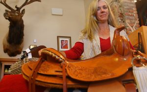 Tamera Schramm, owner of Western Outfitters and DeBerge Saddlery, crafts leather goods by hand, including elaborate saddles. (Photo by Charlie Clark/Cronkite News)