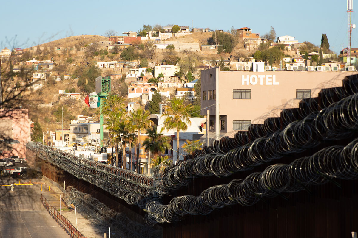 A fence topped with razor wire separates the U.S. from Mexico in Nogales. The fence does little to stop would-be drug smugglers, however. In fiscal year 2020, agents seized more than 42,645 pounds of cocaine, 5,222 pounds of heroin, 324,973 pounds of marijuana, 156,901 pounds of methamphetamine and 3,967 pounds of fentanyl. (Photo by Kenny Quayle/Special for Cronkite News)
