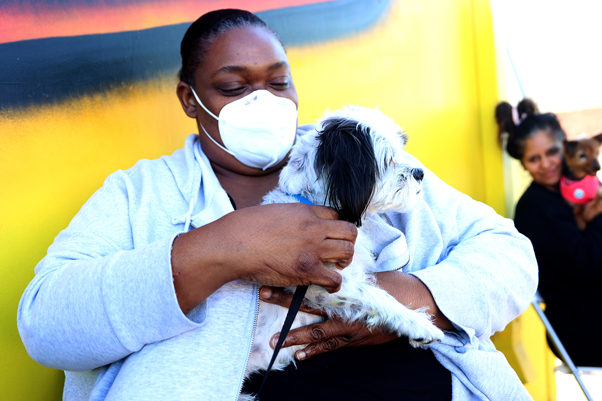 Shaunie Davie and Cash, her half-cocker spaniel, half-Shih Tzu, wait for Cash’s turn to get vaccinated at the Arizona Humane Society’s Healthy Tails Mobile Veterinary Clinic in downtown Phoenix on Jan. 21. (Photo by Troy Hill/Cronkite News)
