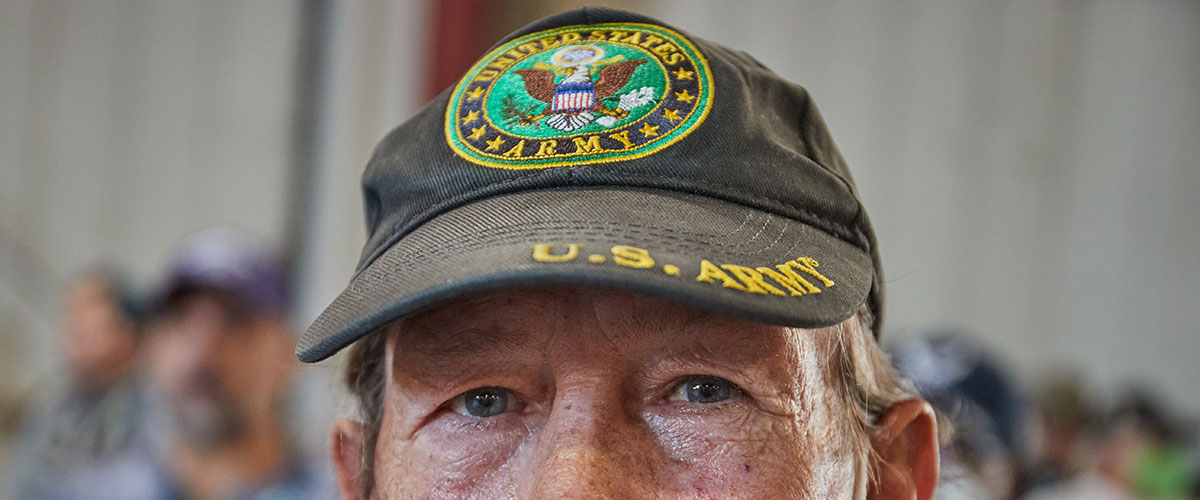 Army veteran Dan Mosher, 64, poses for a photo while waiting for a haircut and other services at the 2022 Maricopa County StandDown at the Arizona State Fairgrounds in Phoenix on Thursday, March 17, 2022. (Photo by Alex Gould/Cronkite News)
