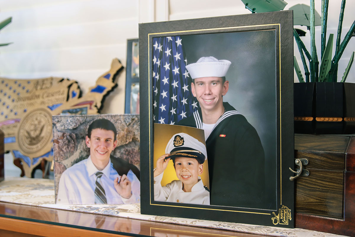 Photos of Brandon Caserta decorate the Peoria home of his parents, Teri and Patrick. After their son died by suicide in the Navy, the couple lobbied Congress for legislation to expand mental health services to members of the military. (Photo by Madeline Bautista/Cronkite News)
