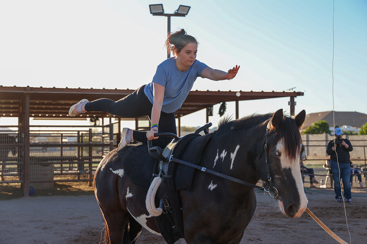 After finding Salt River Vaulters, Allyson Ward’s life changed greatly, giving her the ability to better cope with her disabilities. After just two months of practicing, Ward was able to stand on the horse. (Photo by Mary Grace Grabill/Cronkite News)
