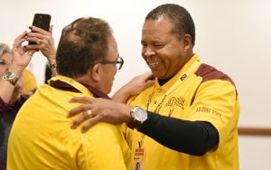 Two players from the 1982-1983 ASU football team embrace each other at the luncheon Friday at the Sheraton Phoenix Downtown to honor the Sun Devils Fiesta Bowl win against Oklahoma. (Photo by Tim Trumble/Tim Trumble Photography)