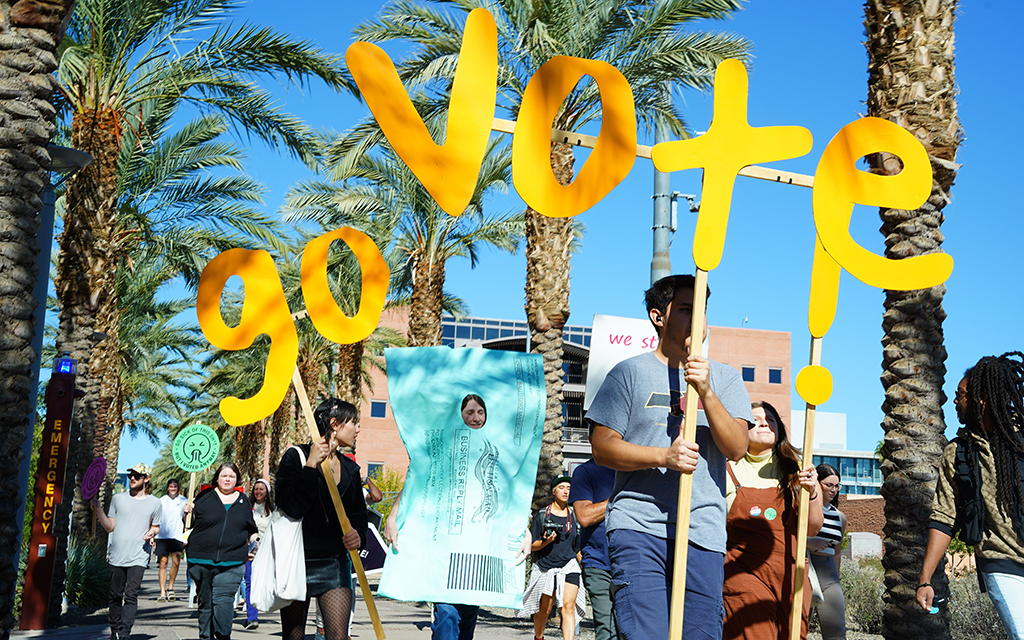 Students march along Arizona State University’s Palm Walk to encourage new and first-time voters in Maricopa County to vote on Tuesday, Nov. 8, 2022, in Tempe, Ariz. (Photo by Kiersten Edgett/Special for Cronkite News)