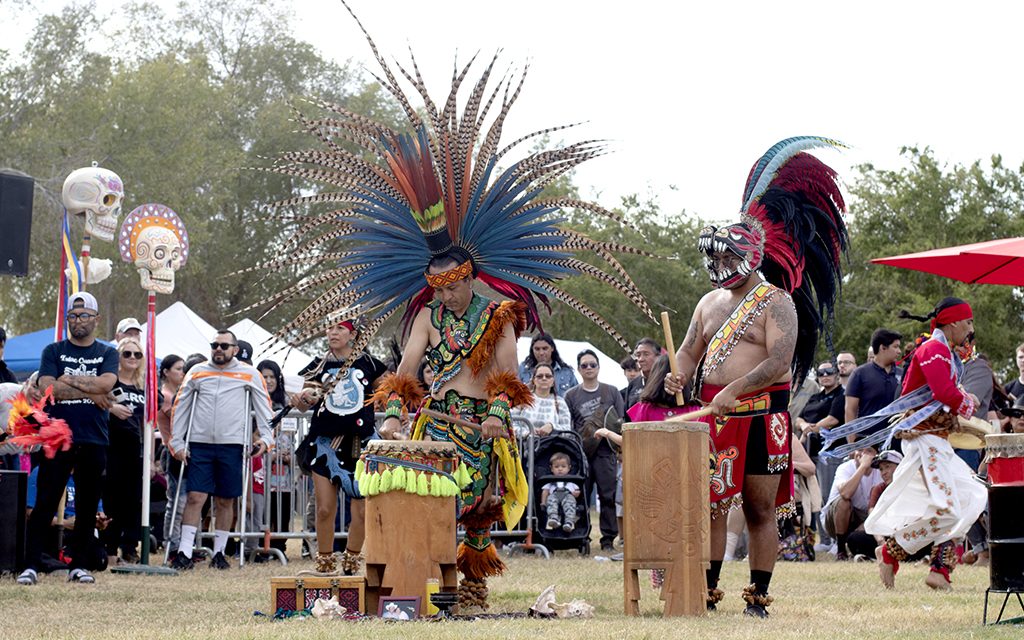 Members of an Indigenous dance group dress in traditional uniforms and beat a drum during an ancestral dance at the Mikiztli festival on Oct. 30, 2022, at Steele Indian School Park in Phoenix. (Photo by Scianna Garcia/ Cronkite News)