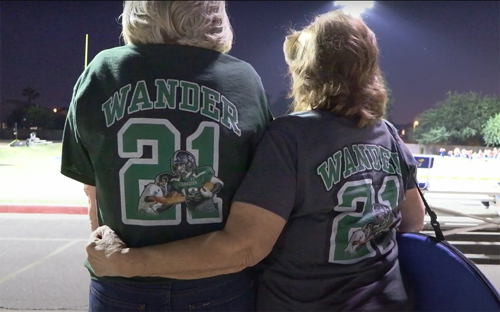 Aiden Wander's grandmother, left, and mother show support for Aiden Wander at Arete Prep's senior night with personalized T-shirts. (Photo by Michele Aerin/Cronkite News)
