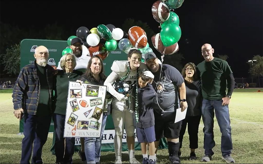Aiden Wander poses with his family at Arete Prep's senior night, which marked his final high school football game. (Photo by Michele Aerin/Cronkite News)