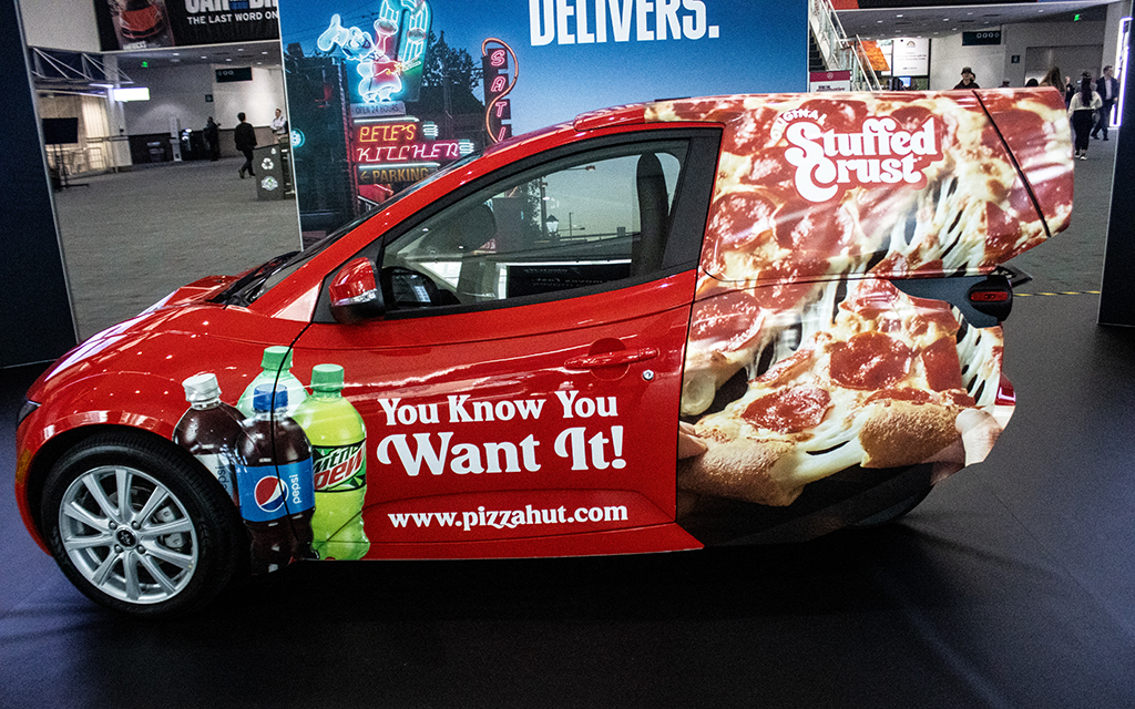 An ElectraMeccanica Solo that's outfitted to deliver pizzas is displayed Nov. 17 at the Los Angeles Auto Show. (Photo by Emeril Gordon/Cronkite News)