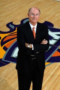 Harvey Shank stands at the center of the Phoenix Suns' home court in the arena he helped secure the naming rights for as a Suns executive. Now called the Footprint Center, it was once the Talking Stick Resort Arena, U.S. Airways Center and America West Arena. (Photo courtesy of Harvey Shank)