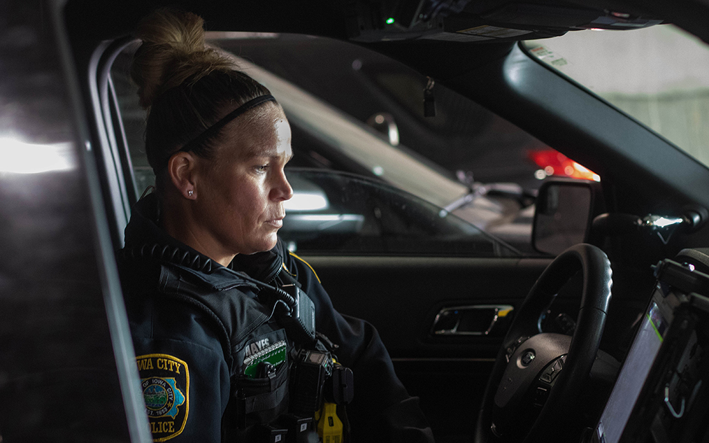 Officer Ashten Hayes of the Iowa City Police Department checks her patrol car's computer before her shift begins on April 18, 2022. After going to school for nursing, Hayes switched career paths to law enforcement "because I saw law enforcement as a noble job.” (Photo by Kate Heston/News21)