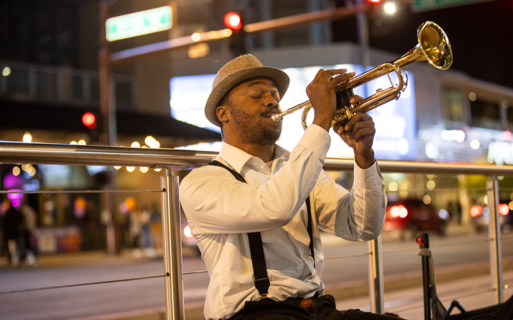 Trumpet player Edward Conway performs outside Footprint Center following a Suns victory over the Warriors on Nov. 16. Conway started busking out of necessity. (Photo by Nikash Nath/Cronkite News)