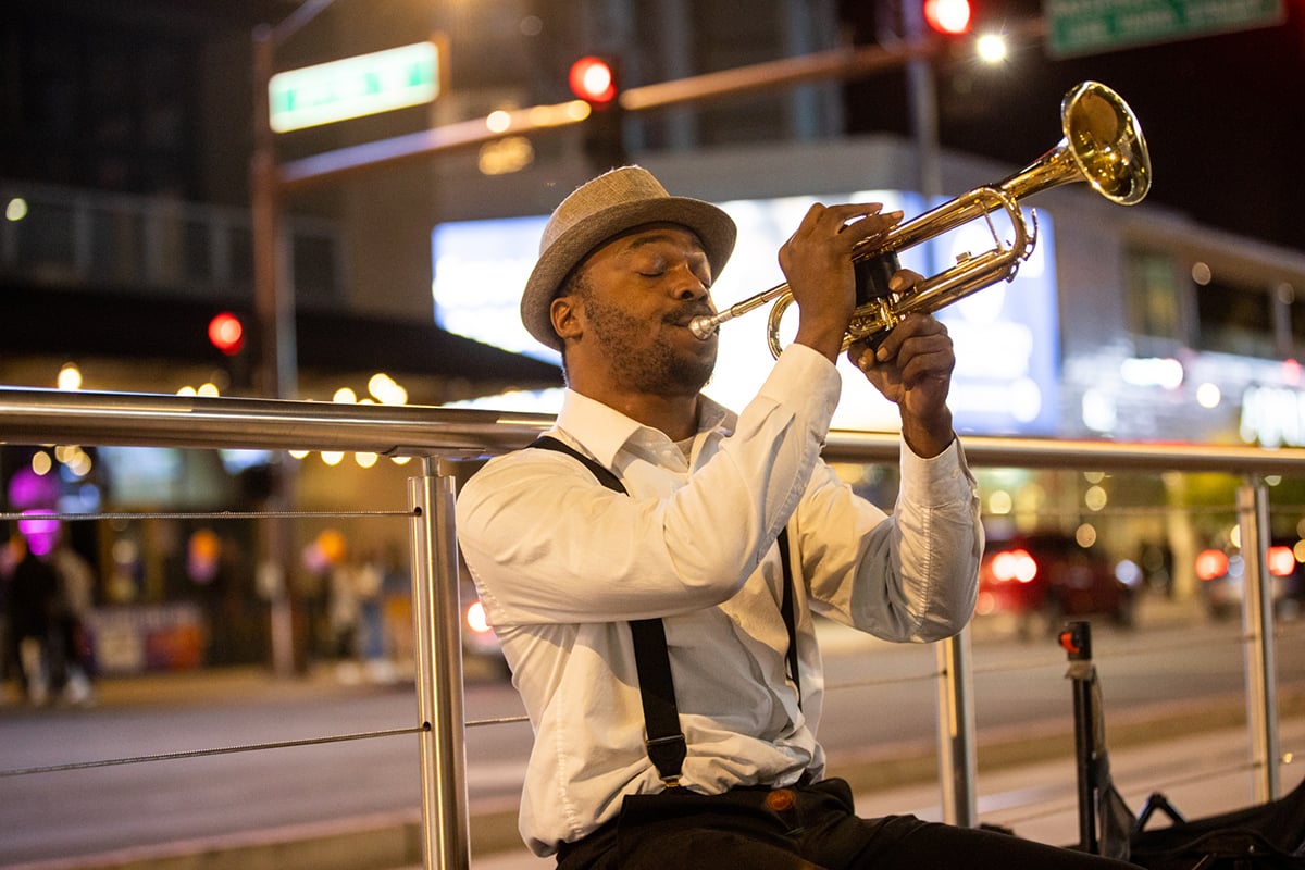 Trumpet player Edward Conway performs outside Footprint Center following a Suns victory over the Warriors on Nov. 16. Conway started busking out of necessity. (Photo by Nikash Nath/Cronkite News)
