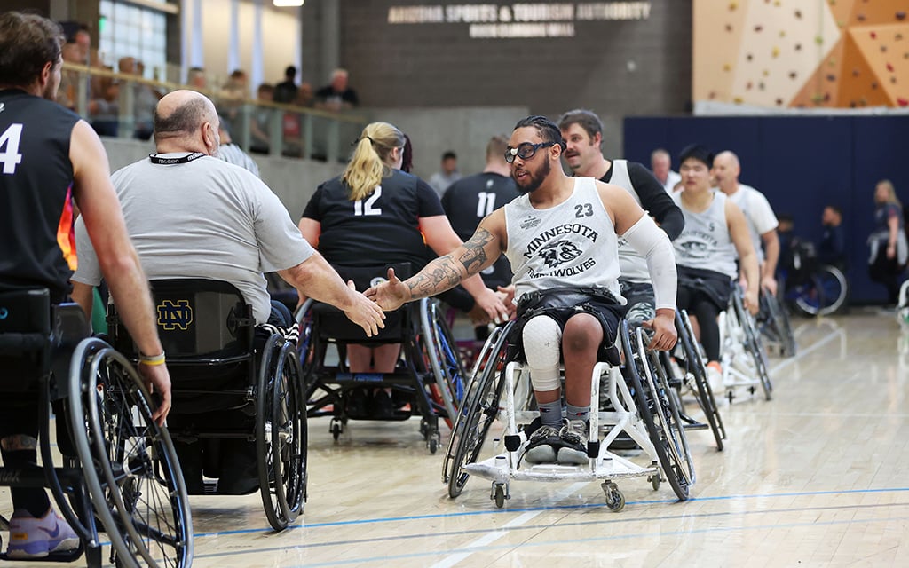 The Courage Kenny Rolling Timberwolves and the Ability360 Wheelchair Suns line up and shake hands after their game at the 23rd Annual D1 Phoenix Invitational at Ability360 in Phoenix Jan. 28, 2023. (Photo by Brooklyn Hall/Cronkite News)