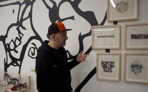 Beyond the Streets founder Roger Gastman is surrounded by Beastie Boys memorabilia displayed at their exhibit in Los Angeles. Photographed on Jan. 19, 2023. (Photo by Daniel Ogas/Cronkite News)