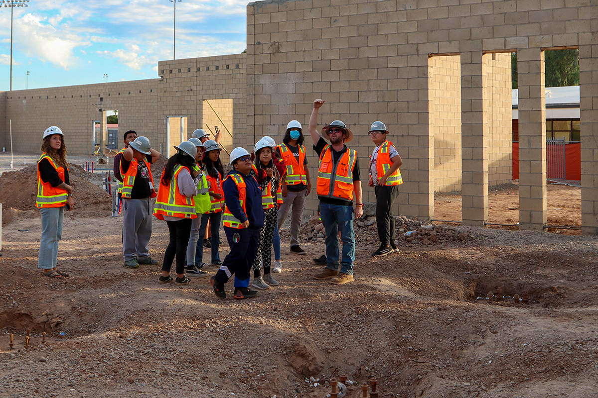 Nelson Martinez Jr., the jobsite superintendent for Chasse Building Team, shows students where the library will be in Madison Park Middle School’s addition. Photo taken Nov. 1, 2022, at the school in Phoenix. (Photo by Justin Spangenthal/Cronkite News)