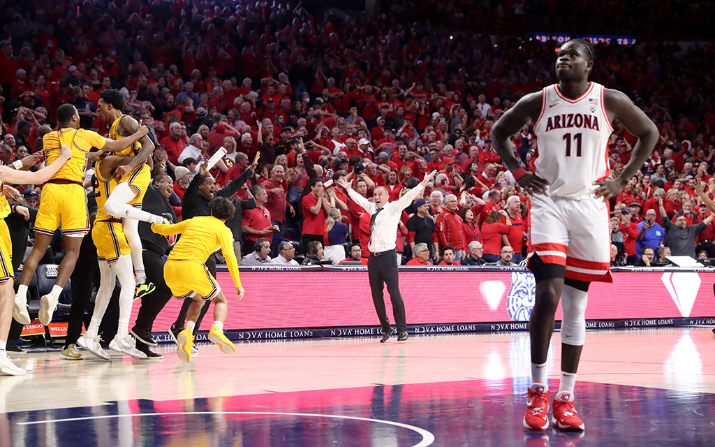 Arizona State men’s basketball coach Bobby Hurley and his team celebrate a desperation shot by Desmond Cambridge Jr. that lifted the Suns Devils to a victory over Arizona and center Oumar Ballo at McKale Center in Tucson. (Photo by Christopher Hook/Icon Sportswire via Getty Images)
