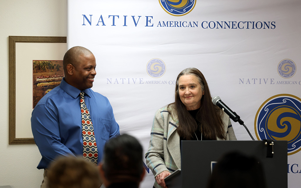 Diana Yazzie Devine, CEO of Native American Connections, right, introduces Michael Lafitte, director of HomeBase Surprise, at the grand opening of HomeBase Surprise on Feb. 2, 2023. (Photo by Logan Camden/Cronkite News)