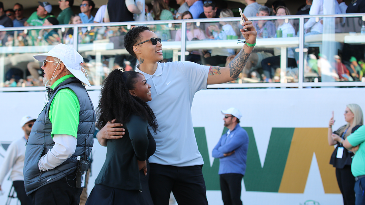 Brittney Griner, right, makes just her second public appearance since her release from a Russian prison, showing up with with her wife, Cherelle, at the WM Phoenix Open. (Photo by: Matt Venezia/Cronkite News)