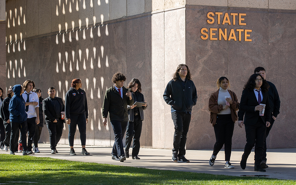 Students walk to a meeting with state legislators on Feb. 15, 2023. Aliento, a youth-led education nonprofit serving undocumented young people, DACA recipients and members of mixed-status families, trains the students to help them concisely explain their legislative priorities. (Photo by Drake Presto/Cronkite News)